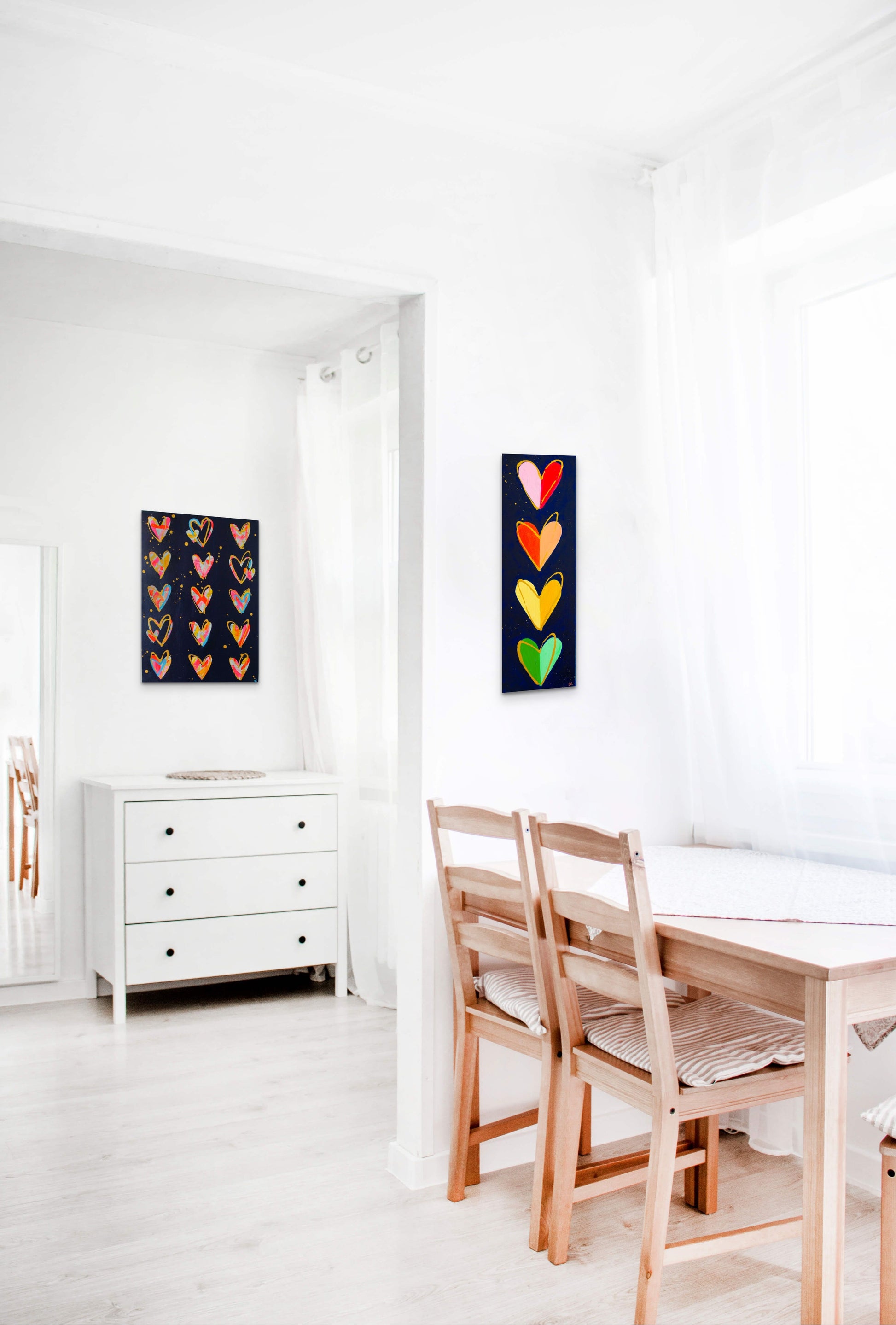 Two paintings with hearts from Bridget Edwards Studio hang on white walls in clean, modern house. Art work for sale.