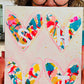 colorful mixed media held by the artist outdoors