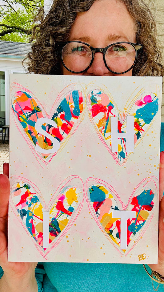 colorful mixed media held by the artist outdoors