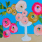 Colorful floral arrangement with a white vase on a blue background